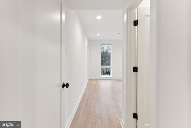 corridor with light hardwood / wood-style flooring