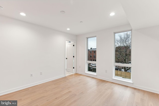 spare room featuring light hardwood / wood-style flooring