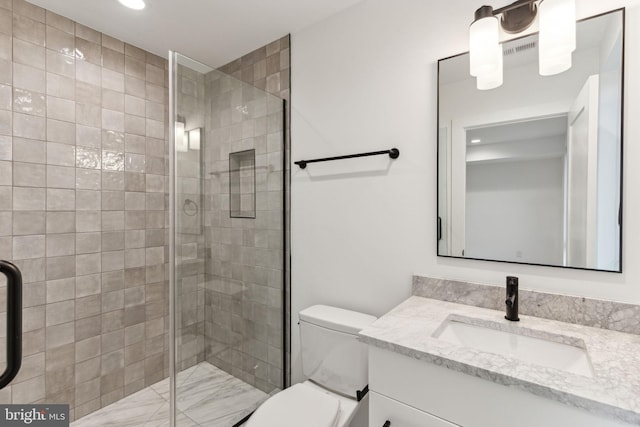 bathroom featuring vanity, toilet, and walk in shower