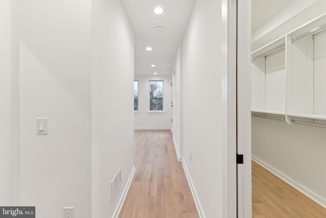 corridor featuring light hardwood / wood-style floors