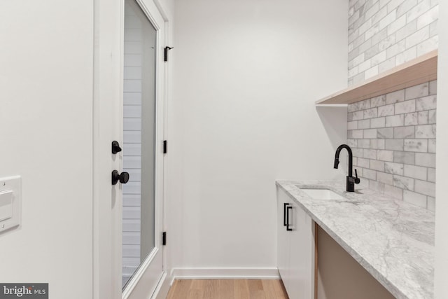 laundry area featuring light hardwood / wood-style flooring and sink