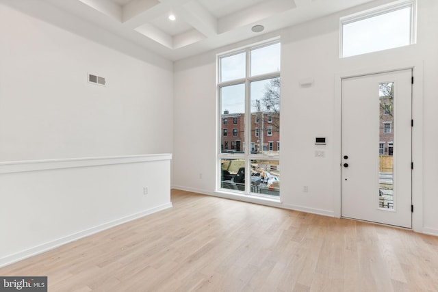 foyer featuring beamed ceiling, a high ceiling, light hardwood / wood-style flooring, and coffered ceiling