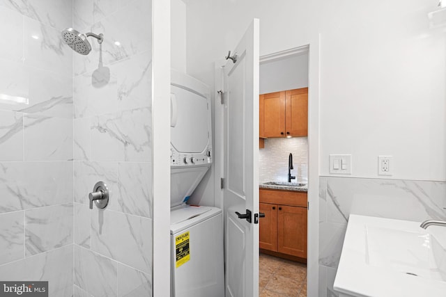 laundry area featuring stacked washer and dryer and sink