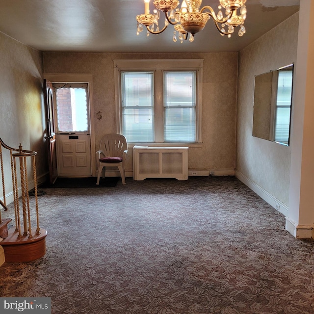 carpeted spare room with radiator and an inviting chandelier