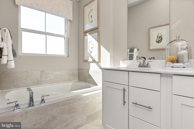 bathroom featuring vanity and tiled tub