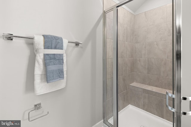 bathroom with a shower with door