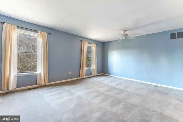 empty room with ceiling fan and light colored carpet