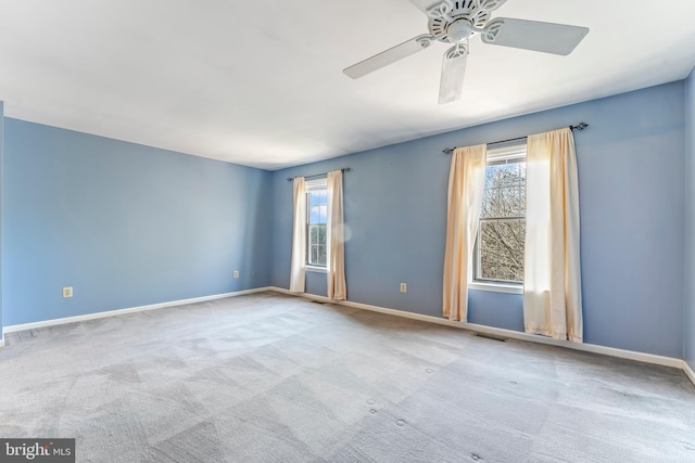 carpeted empty room featuring ceiling fan