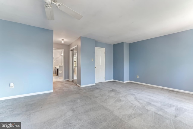 spare room featuring ceiling fan and light carpet