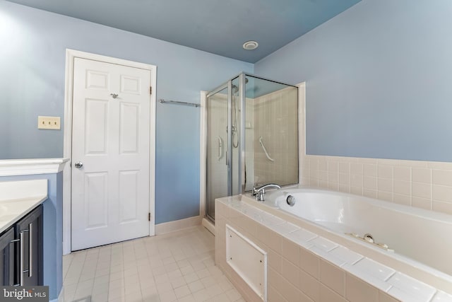 bathroom with tile patterned floors, vanity, and shower with separate bathtub