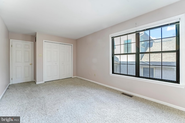 unfurnished bedroom featuring a closet and carpet