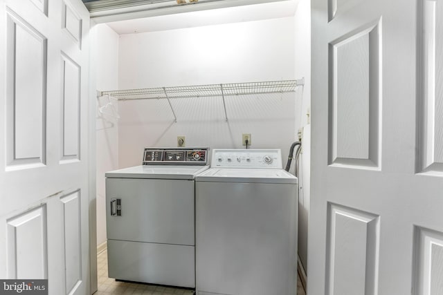 clothes washing area with washing machine and dryer