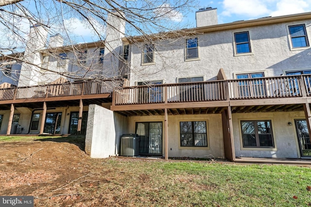 back of property featuring central AC