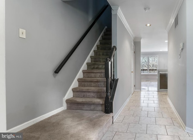 stairway with crown molding and tile patterned flooring