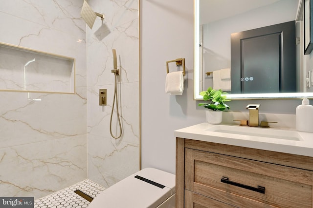 bathroom featuring vanity and tiled shower