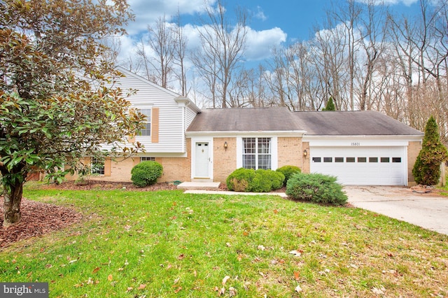 split level home with a garage and a front lawn