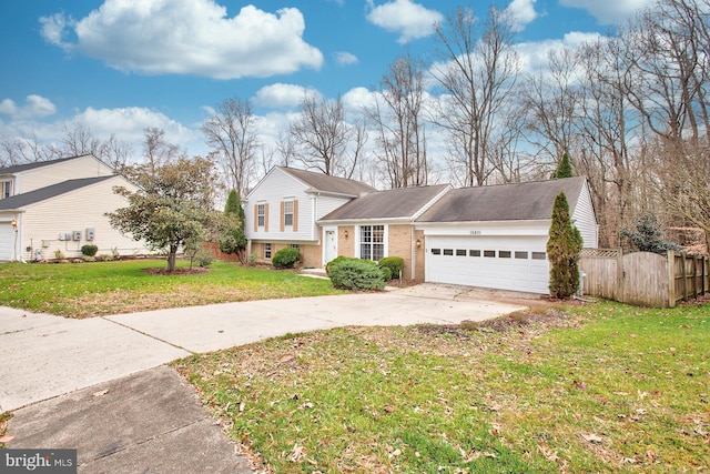 split level home with a front lawn and a garage