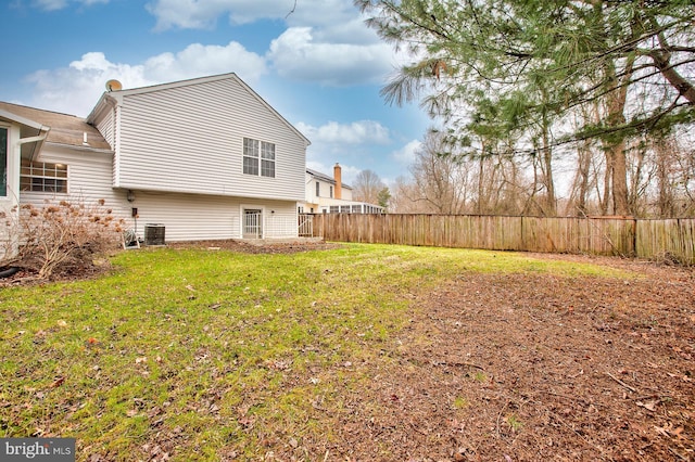 back of house featuring a yard and cooling unit