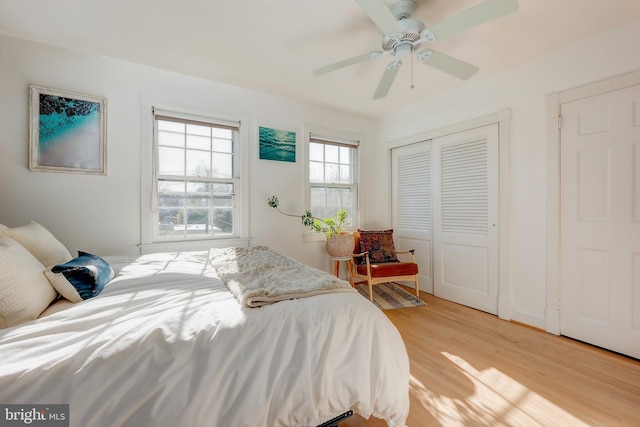 bedroom with ceiling fan, a closet, and light wood-type flooring