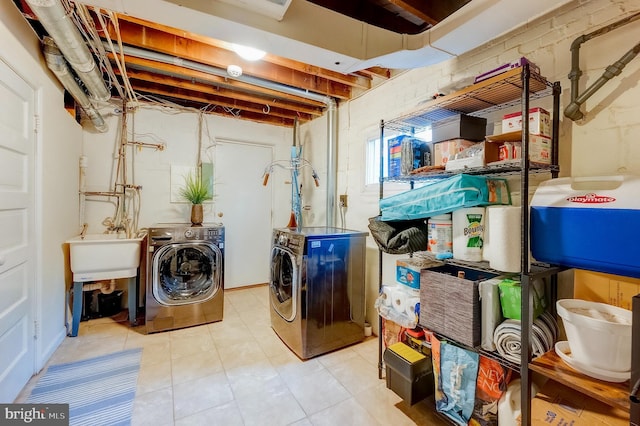 washroom featuring independent washer and dryer and sink