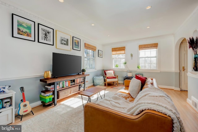 living room featuring ornamental molding and light hardwood / wood-style floors