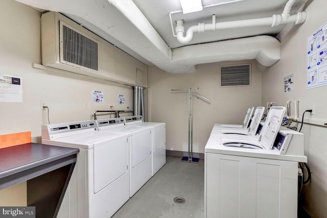 clothes washing area featuring washer and dryer