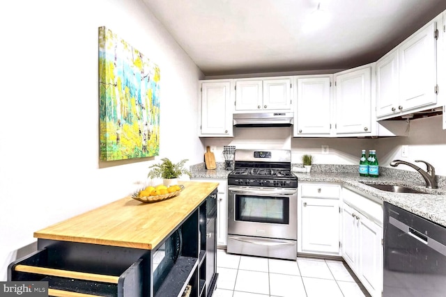 kitchen featuring stainless steel gas stove, black dishwasher, sink, white cabinets, and light tile patterned floors