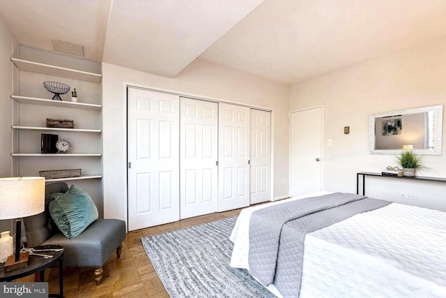 bedroom with a closet and light parquet floors