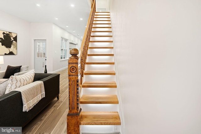 staircase featuring hardwood / wood-style flooring