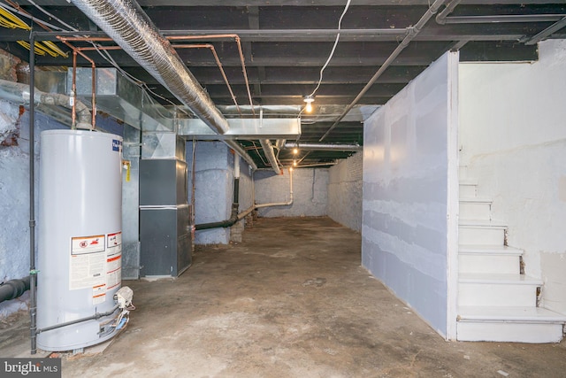 basement featuring heating unit and water heater