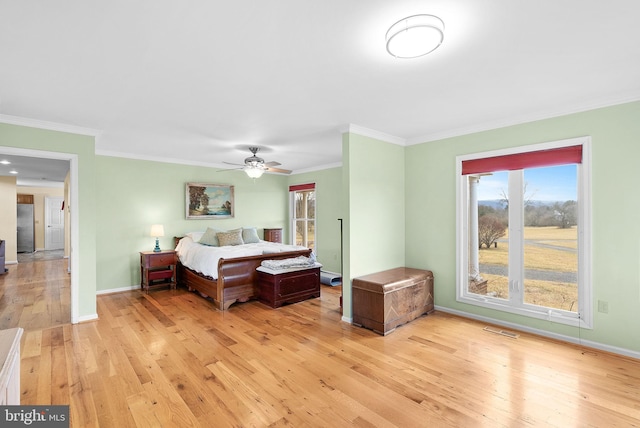 bedroom with crown molding, ceiling fan, stainless steel refrigerator, and light hardwood / wood-style flooring