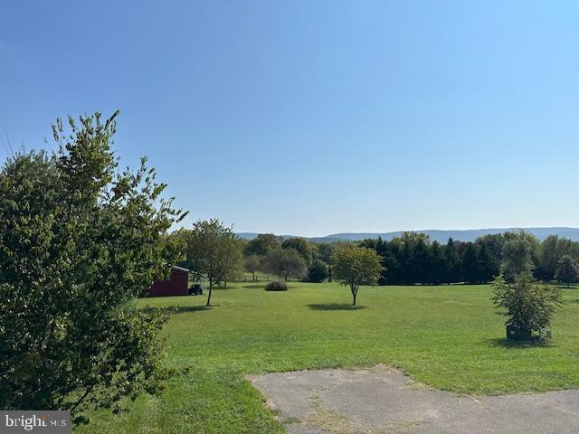 view of community featuring a rural view and a lawn