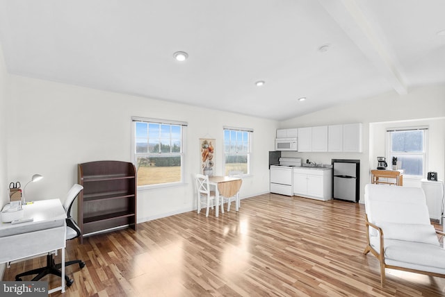 kitchen with white appliances, light hardwood / wood-style flooring, lofted ceiling with beams, and white cabinets