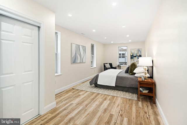 bedroom featuring light wood-type flooring and a closet