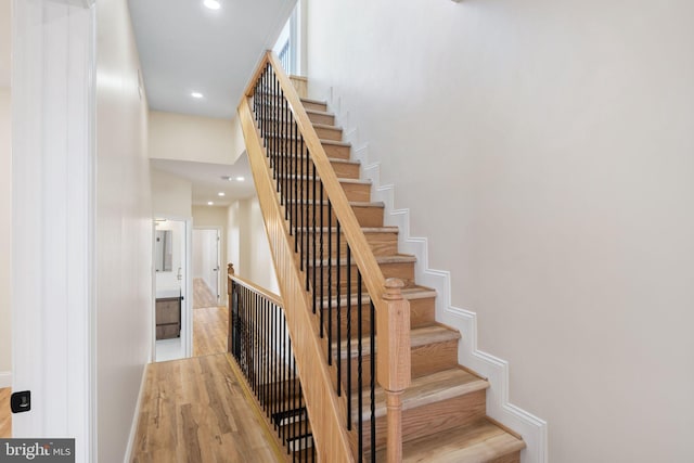 staircase with hardwood / wood-style floors