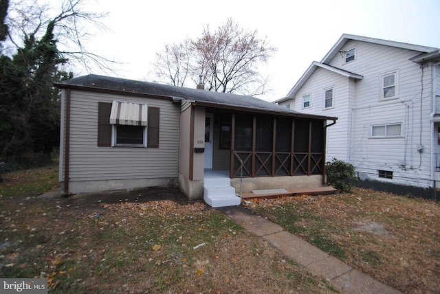 view of front of house with a sunroom