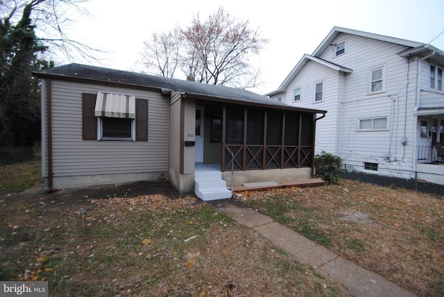 view of front of house with a sunroom