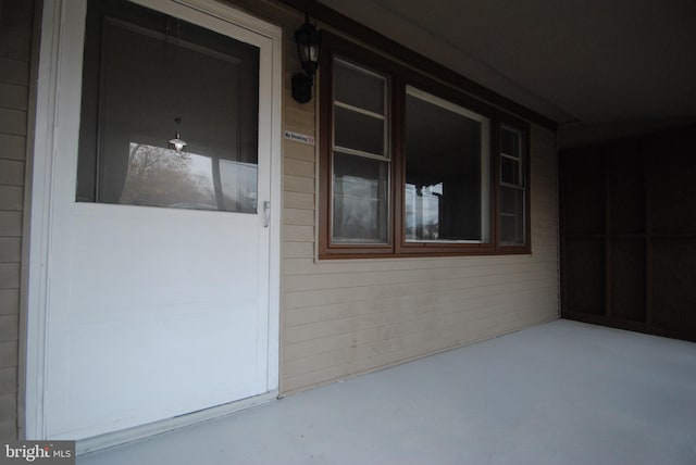 view of exterior entry with a porch