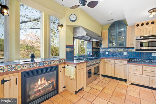 12330 Potomac View Rd, Newburg, MD 20664 - kitchen featuring light brown cabinets, wall chimney range hood, stainless steel appliances, and tasteful backsplash