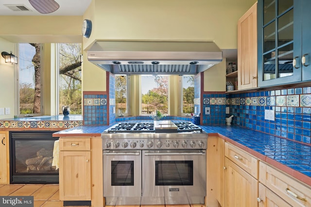 12330 Potomac View Rd, Newburg, MD 20664 - kitchen with range with two ovens, light brown cabinets, backsplash, and glass insert cabinets