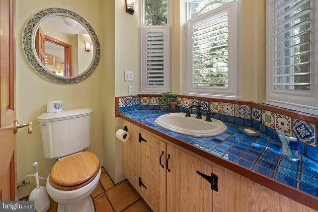 12330 Potomac View Rd, Newburg, MD 20664 - bathroom featuring toilet, vanity, decorative backsplash, and tile patterned floors