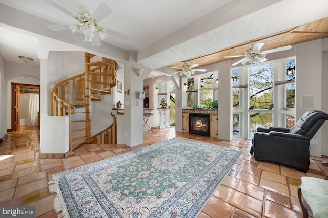 living room featuring a wealth of natural light and ceiling fan