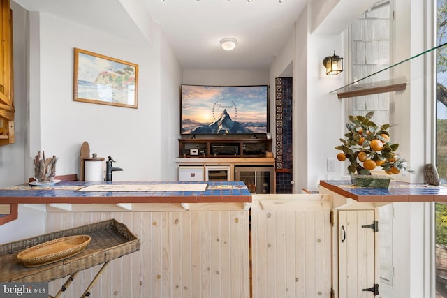 bar featuring tile countertops and plenty of natural light