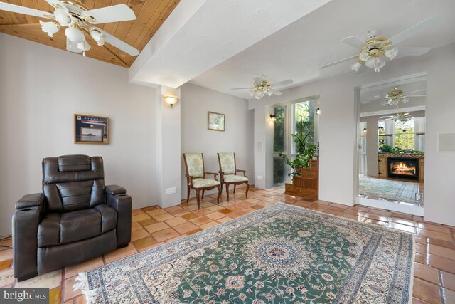 12330 Potomac View Rd, Newburg, MD 20664 - sitting room featuring ceiling fan, tile patterned floors, a lit fireplace, and wood ceiling