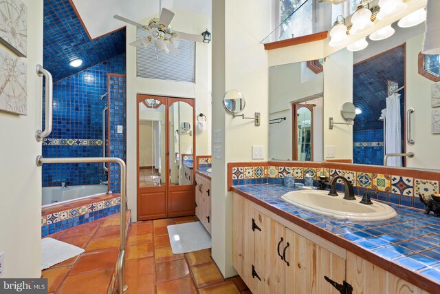 12330 Potomac View Rd, Newburg, MD 20664 - full bath featuring vanity, a ceiling fan, tiled shower / bath, decorative backsplash, and high vaulted ceiling