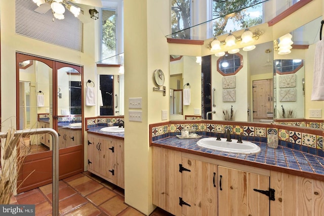 12330 Potomac View Rd, Newburg, MD 20664 - bathroom with a towering ceiling, two vanities, and a ceiling fan