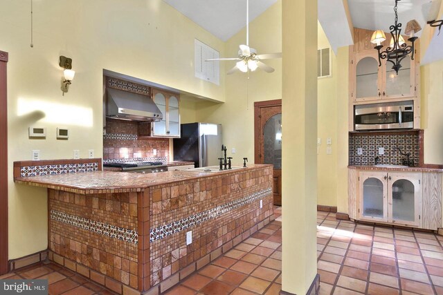 12330 Potomac View Rd, Newburg, MD 20664 - kitchen with stainless steel microwave, wall chimney range hood, freestanding refrigerator, a sink, and range