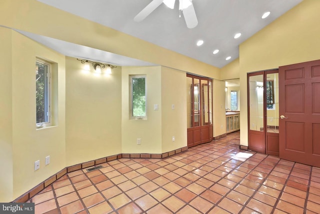 tiled entryway featuring ceiling fan, a healthy amount of sunlight, and vaulted ceiling