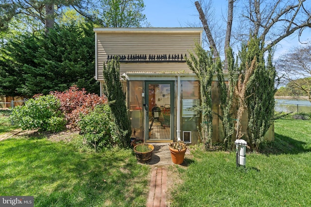 view of outbuilding featuring a lawn