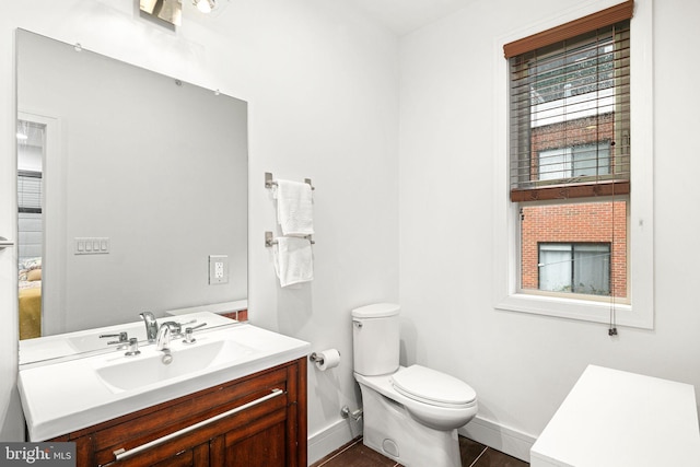 bathroom with tile patterned floors, vanity, and toilet